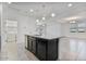 Eat-in kitchen features an island with breakfast bar that connects to an open living area at 4125 W Gary Way, Laveen, AZ 85339
