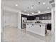 Modern kitchen with a central island, dark cabinetry, and stainless steel appliances offers a stylish and functional space at 4125 W Gary Way, Laveen, AZ 85339