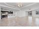 Open-concept living space with tile floors and views of the kitchen and backyard, perfect for modern living at 4125 W Gary Way, Laveen, AZ 85339