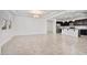 Bright living room with tile flooring, tray ceilings, stylish lighting, and an open view of the modern kitchen at 4125 W Gary Way, Laveen, AZ 85339