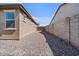 Gravel-covered side yard leading to a wood fence at 4125 W Gary Way, Laveen, AZ 85339