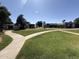 Scenic community shot with winding sidewalk and lawn, showcasing the well-maintained grounds and peaceful environment at 4652 W Desert Crest Dr, Glendale, AZ 85301