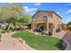 Expansive backyard view featuring desert landscaping and patio with balcony above at 4976 E Thunderbird Dr, Chandler, AZ 85249