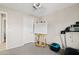 A bright bedroom featuring an easel, treadmill, and large window at 4976 E Thunderbird Dr, Chandler, AZ 85249