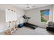 A bright bedroom featuring an easel, treadmill, large window, and beverage cooler at 4976 E Thunderbird Dr, Chandler, AZ 85249