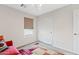 A bright bedroom with a large window, a closet, and an orange couch at 4976 E Thunderbird Dr, Chandler, AZ 85249