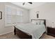 Cozy bedroom with shuttered windows, ceiling fan, and comfortable queen-size bed at 4976 E Thunderbird Dr, Chandler, AZ 85249