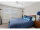 Cozy bedroom featuring a comfortable queen-sized bed with stylish blue bedding and decorative giraffe statues at 4976 E Thunderbird Dr, Chandler, AZ 85249
