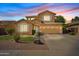 Charming two-story home with well-manicured lawn, desert landscaping, and an inviting facade at dusk at 4976 E Thunderbird Dr, Chandler, AZ 85249