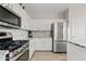 Modern kitchen features stainless steel appliances, granite countertops, and white cabinets at 4976 E Thunderbird Dr, Chandler, AZ 85249