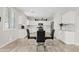 Bright, modern kitchen featuring white cabinets, stainless appliances, and a glass-top dining table at 4976 E Thunderbird Dr, Chandler, AZ 85249