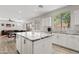 Bright kitchen featuring an island with granite countertops and stainless steel appliances at 4976 E Thunderbird Dr, Chandler, AZ 85249