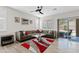 Open living room features a sleek ceiling fan, neutral tones, and glass coffee table at 4976 E Thunderbird Dr, Chandler, AZ 85249