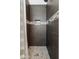 Modern tiled shower with mosaic accent stripe and stone flooring at 4976 E Thunderbird Dr, Chandler, AZ 85249