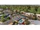 Aerial view of a home with a swimming pool, adjacent to a golf course and lush neighborhood at 524 W Sunset Cir, Mesa, AZ 85201