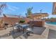 Backyard patio with built in brick bar, a table with seating, and access to the pool at 524 W Sunset Cir, Mesa, AZ 85201