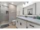 A beautifully renovated bathroom with a glass walk-in shower and a granite vanity top at 524 W Sunset Cir, Mesa, AZ 85201