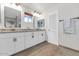 The bathroom features a double vanity with granite counters, white cabinets, and modern fixtures at 524 W Sunset Cir, Mesa, AZ 85201