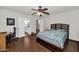 Bedroom showcasing wood floors, ceiling fan, and access to an en-suite bathroom at 524 W Sunset Cir, Mesa, AZ 85201