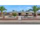 Well-maintained home featuring a brick-and-stone facade with manicured landscaping and a fenced yard at 524 W Sunset Cir, Mesa, AZ 85201