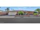 A well-maintained single-story home with a two-car garage and a brick front fence at 524 W Sunset Cir, Mesa, AZ 85201