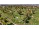 Picturesque aerial view of a lush golf course featuring manicured greens, mature trees, and winding pathways at 524 W Sunset Cir, Mesa, AZ 85201