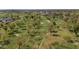 Expansive aerial view of a golf course with rolling greens, mature trees, sand traps and meandering paths at 524 W Sunset Cir, Mesa, AZ 85201