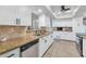 Bright, modern kitchen with stainless steel appliances, granite countertops, and sleek white cabinetry for a clean, updated look at 524 W Sunset Cir, Mesa, AZ 85201