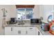 This kitchen area showcases a granite countertop, bright white cabinets, and stainless appliances at 524 W Sunset Cir, Mesa, AZ 85201