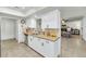 Modern kitchen with stainless steel appliances, granite countertops, and ample cabinet space open to adjacent living area at 524 W Sunset Cir, Mesa, AZ 85201