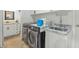 Bright laundry room features modern washer, dryer, sink, and vanity with stone countertop at 524 W Sunset Cir, Mesa, AZ 85201