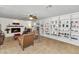 Inviting living room boasts a cozy fireplace and an expansive built-in bookshelf, perfect for display and storage at 524 W Sunset Cir, Mesa, AZ 85201