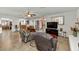 Comfortable living room with seamless access to kitchen and outdoor patio, featuring tile floors and neutral decor at 524 W Sunset Cir, Mesa, AZ 85201