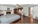 Main bedroom features a fireplace, exterior access, wood floors, and a sliding barn door to bathroom at 524 W Sunset Cir, Mesa, AZ 85201