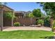 Backyard featuring a patio area, lush lawn, and a desert landscaped wall at 5541 W Desperado Way, Phoenix, AZ 85083