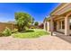 Landscaped backyard with lush lawn, patio, and privacy wall is perfect for outdoor living at 5541 W Desperado Way, Phoenix, AZ 85083