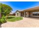 Well maintained backyard featuring green lawn, covered patio, and desert landscaping at 5541 W Desperado Way, Phoenix, AZ 85083