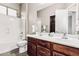 Bathroom featuring double sinks, cherry cabinets, and tub and shower combo at 5541 W Desperado Way, Phoenix, AZ 85083