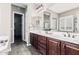 Bathroom featuring dual sinks, dark wood cabinets, and a large mirror at 5541 W Desperado Way, Phoenix, AZ 85083
