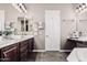 Bathroom with double sinks, granite countertop, and sleek tile floor at 5541 W Desperado Way, Phoenix, AZ 85083