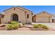 Beautiful home exterior with desert landscaping and a charming, arched window at 5541 W Desperado Way, Phoenix, AZ 85083