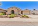 Charming home featuring neutral color palette, arched window, desert landscaping and inviting entry at 5541 W Desperado Way, Phoenix, AZ 85083