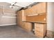 Garage features custom wooden cabinets and a workbench area for organized storage and projects at 5541 W Desperado Way, Phoenix, AZ 85083
