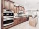 Chef's kitchen featuring stainless steel appliances, island, and abundant cabinet space at 5541 W Desperado Way, Phoenix, AZ 85083