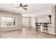 Bright living room featuring natural light, tile floors, and a stylish ceiling fan at 5541 W Desperado Way, Phoenix, AZ 85083