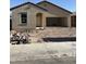 New home under construction, showing the exterior with a two-car garage and an arched entryway at 6029 E Artemis Dr, Florence, AZ 85132