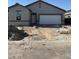 New single-story home in progress with garage, front door, and dirt landscaping at 6036 E Artemis Dr, Florence, AZ 85132