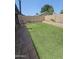 Spacious backyard features manicured artificial turf and a quaint patio area for outdoor enjoyment at 6036 W Mescal St, Glendale, AZ 85304