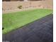 This backyard showcases lush artificial turf and a tiled patio area, perfect for relaxing or entertaining guests at 6036 W Mescal St, Glendale, AZ 85304