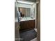 Bathroom vanity with double sinks, a large mirror, and tile flooring at 6036 W Mescal St, Glendale, AZ 85304